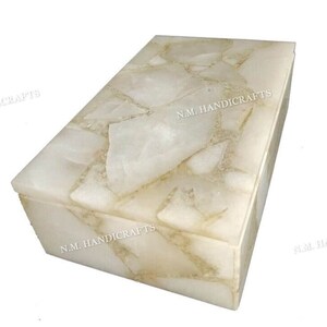 May include: A white rectangular box with a decorative top made of white quartz pieces. The box has the text "N.M. HANDICRAFTS" printed on the side and top.