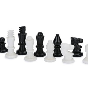 May include: A set of black and white chess pieces made of marble. The pieces are arranged in a row on a white background.