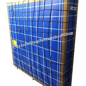 May include: A large cardboard box with a blue and white grid pattern is secured with a black cargo net. The box is labeled with the text "Etsy.com/Shop/NmHandicraftshop".