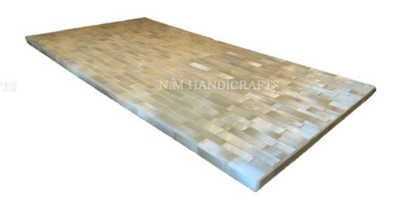 May include: A rectangular table top made of white and beige tiles. The tiles are arranged in a pattern of horizontal rows. The table top is made by NM Handicrafts.
