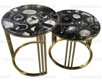 May include: Two round agate stone top side tables with gold metal frames. The tables are nested together.