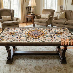 May include: A rectangular coffee table with a detailed inlaid marble top featuring a central circular design in shades of blue, yellow, and red. The table has a dark brown wooden base and legs, and is set in a living room.