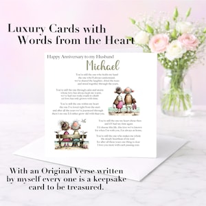 May include: A square white anniversary greeting card for a husband named Michael, featuring a printed poem and two whimsical illustrations of an elderly couple. The card includes text about love and shared years, displayed on a white envelope.