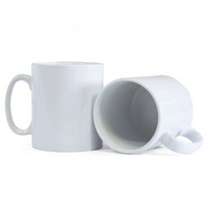 May include: Two white ceramic mugs with handles. The mugs are empty and ready to be filled with a hot beverage.