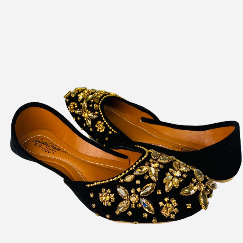 May include: Black velvet shoes with gold and clear rhinestone embellishments. The shoes have a pointed toe and a low heel. The insole is brown leather with the text "Sandal House KH-2007".