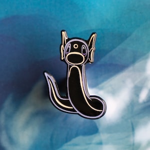 Pin de esmalte Drati con brillo de neón