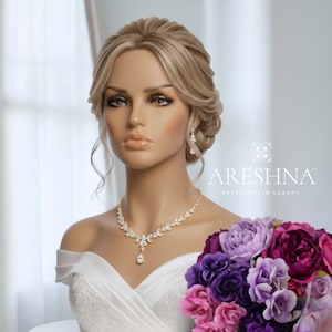 Bride mannequin wearing The Aurora by Areshna™, a floral Swarovski crystal necklace and earrings set in 18K gold, designed for elegant brides and special occasions
