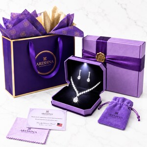 Areshna™ luxury jewelry gift set featuring a Swarovski crystal and DIAMONASH™ lab-created diamond simulant necklace and earrings in a purple LED lighted jewelry box, with boutique gift packaging and Certificate of Authenticity.