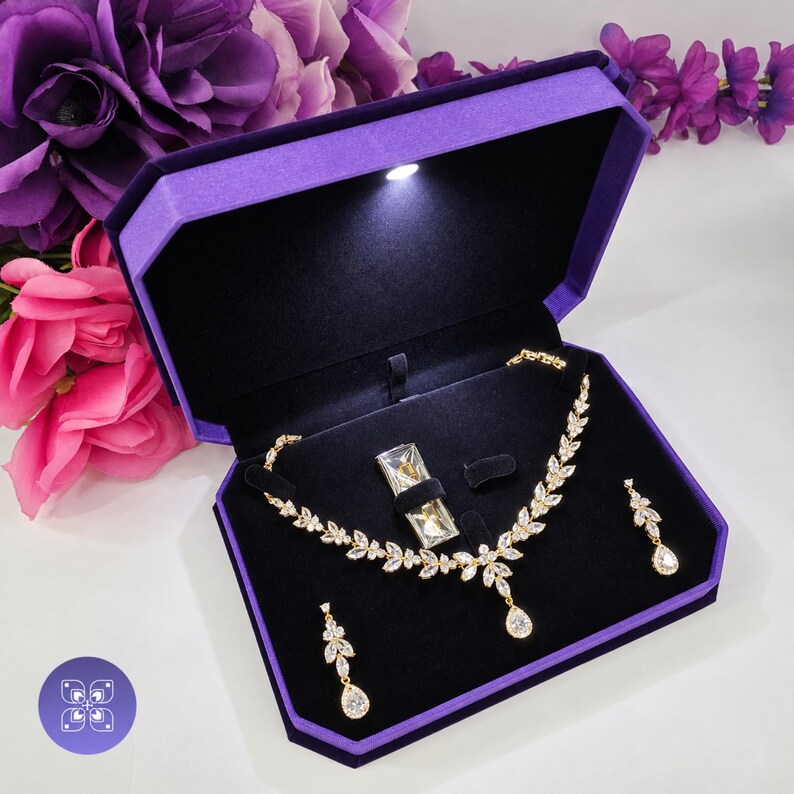 Real Areshna™ The Aurora necklace and earrings with Swarovski crystals and DIAMONASH™ lab-created diamond simulants, shown in the purple LED lighted jewelry presentation box included with the set.