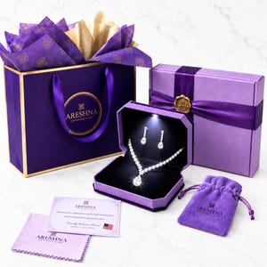 Areshna™ luxury jewelry gift set featuring a Swarovski crystal and DIAMONASH™ lab-created diamond simulant necklace and earrings in a purple LED lighted jewelry box, with boutique gift packaging and Certificate of Authenticity.