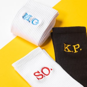 Custom embroidered unisex socks with different colour lettering embroidered on each side