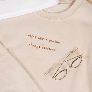 Custom sand coloured sweatshirt with funny inspirational quote embroidered on it