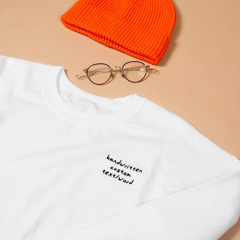 Orange beanie with stylish sunglasses and white custom embroidered sweatshirt