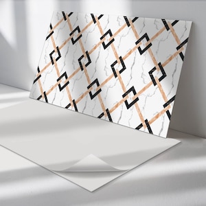 May include: White marble tile with a geometric pattern of black and gold squares. The pattern is repeated across the tile.