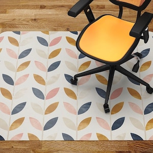 May include: A white, patterned floor mat with a repeating design of pink, gold, and blue leaves. A black office chair with a yellow seat is sitting on the mat.
