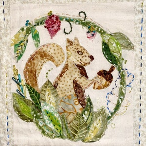 May include: A brown and white squirrel holding an acorn, surrounded by green leaves and berries, in a circular frame.