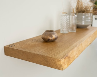 Floating wall shelf made of natural oiled solid oak wood with and without tree edge. Wall shelf in various sizes. Decoration for the living room and kitchen