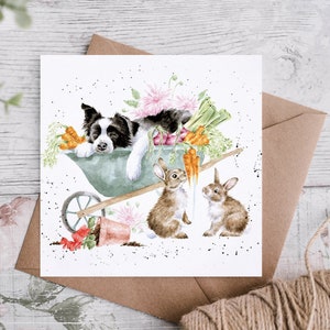 May include: A watercolour greeting card showing a black and white dog in a wheelbarrow with vegetables and flowers. Two brown rabbits are in front. The card is on a white background with a brown envelope.