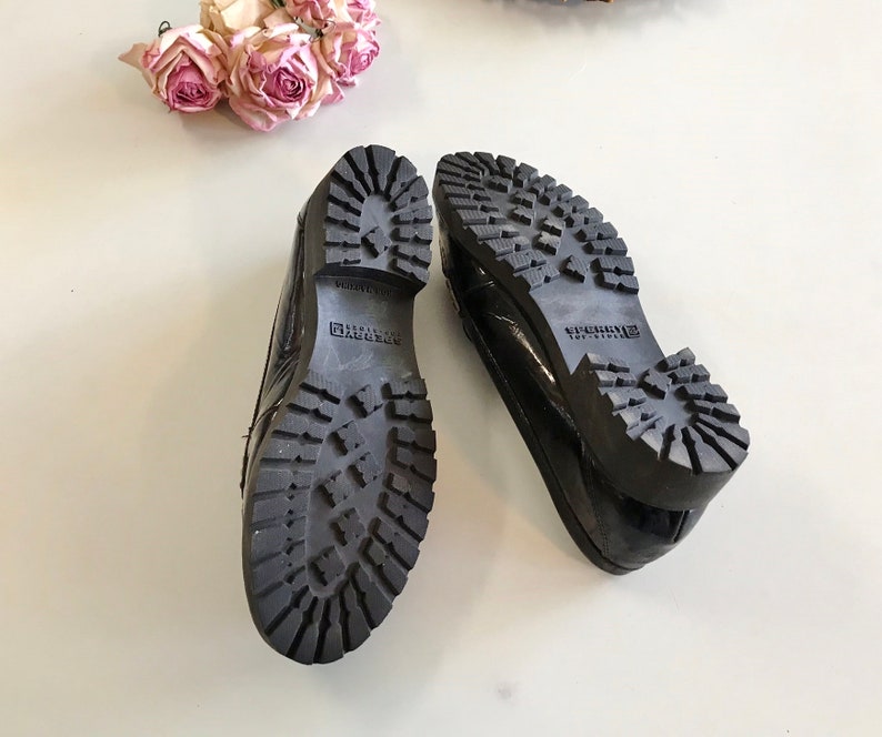 These vintage SPERRY TOP-SiDER PENNY LOAFERS are in GREAT condition 'cause they've never been worn.  Good looking black patent leather with white stitching and lug rubber sole.  Size 7.5. Don't forget to put a penny in the slot!