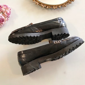 These vintage SPERRY TOP-SiDER PENNY LOAFERS are in GREAT condition 'cause they've never been worn.  Good looking black patent leather with white stitching and lug rubber sole.  Size 7.5. Don't forget to put a penny in the slot!