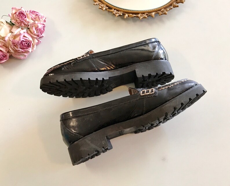 These vintage SPERRY TOP-SiDER PENNY LOAFERS are in GREAT condition 'cause they've never been worn.  Good looking black patent leather with white stitching and lug rubber sole.  Size 7.5. Don't forget to put a penny in the slot!
