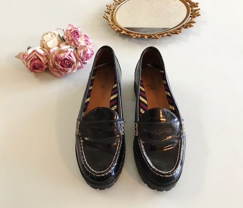 These vintage SPERRY TOP-SiDER pENNY LOAFERS are in EXCELLENT condition 'cause they've NEVER been worn!  They're shiny black patent leather with white stitching and of course, the slot to stick a penny in.  Black lug soles of non-marking rubber.  They're VERY clean with NO wear.  Size 7.5.