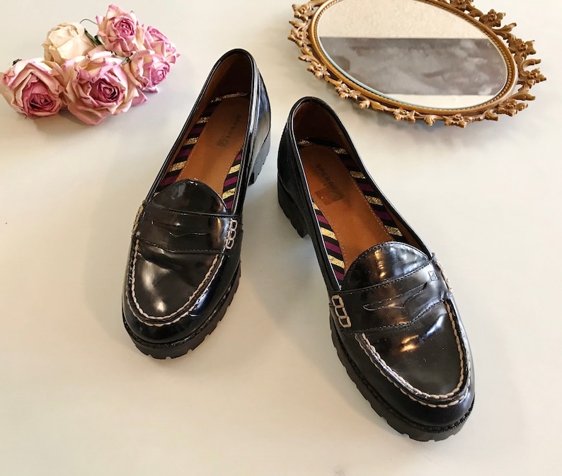 These vintage SPERRY TOP-SiDER pENNY LOAFERS are in EXCELLENT condition 'cause they've NEVER been worn!  They're shiny black patent leather with white stitching and of course, the slot to stick a penny in.  Black lug soles of non-marking rubber.  They're VERY clean with NO wear.  Size 7.5.