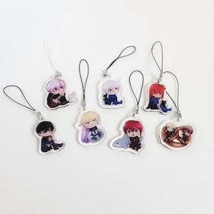 May include: A collection of seven clear acrylic charms featuring chibi-style anime characters. Each charm includes a black or white cord loop for hanging. The designs depict various figures with colourful hair, including one with a shark and one with a pretzel.