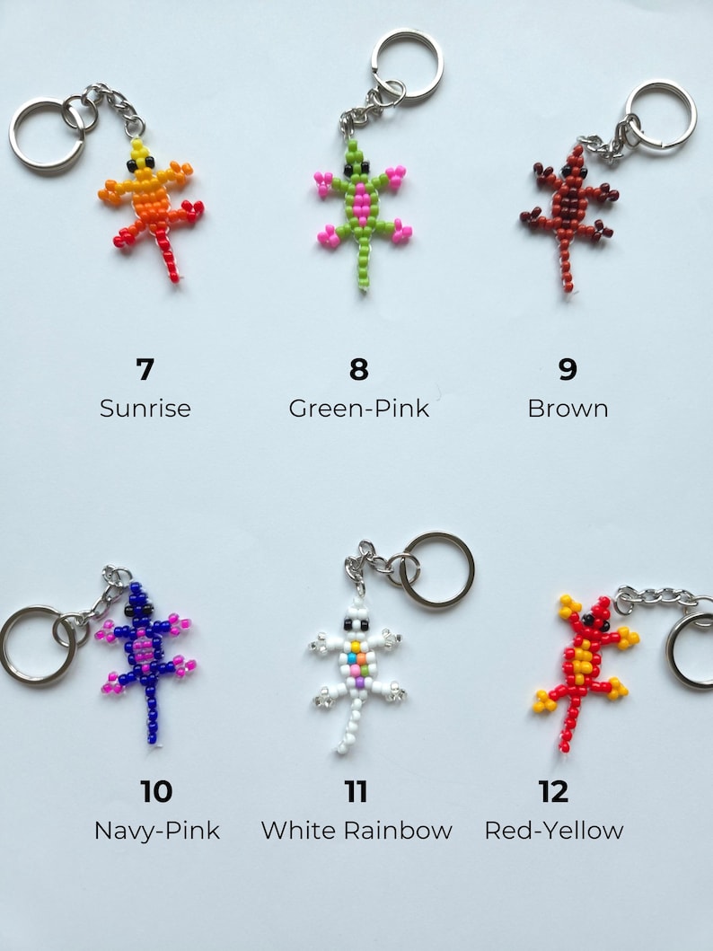 May include: Six lizard-shaped keychains made of small beads, each with a metal ring. The designs are labeled 7 Sunrise (orange-yellow), 8 Green-Pink, 9 Brown, 10 Navy-Pink, 11 White Rainbow, and 12 Red-Yellow, showcasing various color combinations.