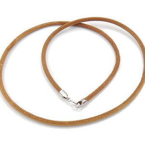 May include: A brown leather cord necklace with a silver clasp.