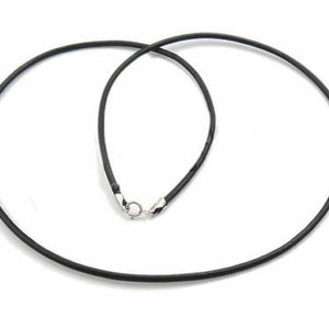 May include: A black leather cord necklace with a silver clasp.