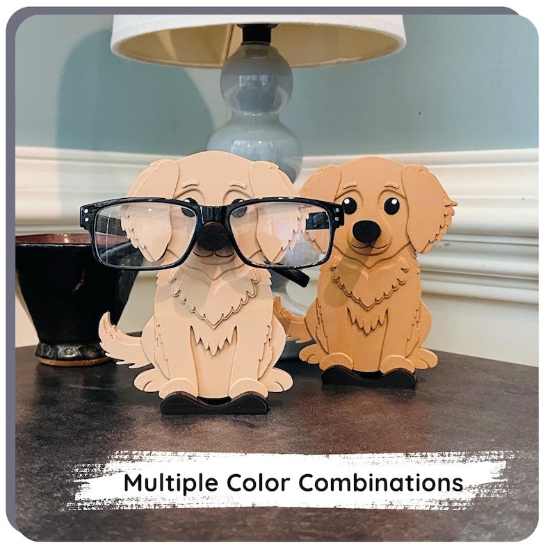 May include: Two wooden dog figurines, one wearing black glasses, holding glasses. The dogs are sitting on a brown surface. Multiple Colour Combinations.