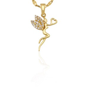 May include: A gold-colored pendant necklace featuring a fairy design. The fairy has crystal-studded wings and is holding a heart. The necklace chain is also gold-colored.