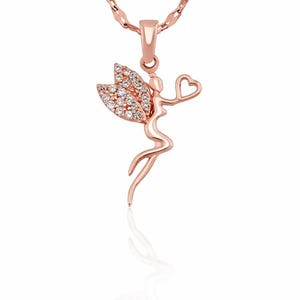 May include: Rose gold pendant necklace featuring a fairy design. The fairy holds a heart and has crystal-studded wings. The pendant hangs from a delicate chain. The jewelry is displayed against a white background.