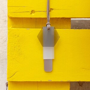 Modern acrylic necklace in gray, silver and white with gray suede cord