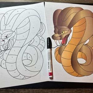 May include: A black and white line art image of a snake with numbered sections. The image is on a white sheet of paper. There is a colored image of a snake on a separate sheet of paper. The colored snake is brown with yellow eyes and a red tongue. The image is on a white sheet of paper.