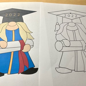 May include: A black and white coloring page featuring a graduation gnome wearing a cap with the year 2022 on it. The gnome is holding a diploma scroll and has a long beard.