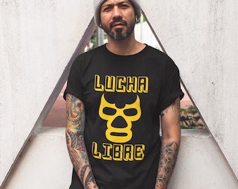 May include: A black t-shirt with a yellow graphic of a wrestling mask and the text "LUCHA LIBRE".