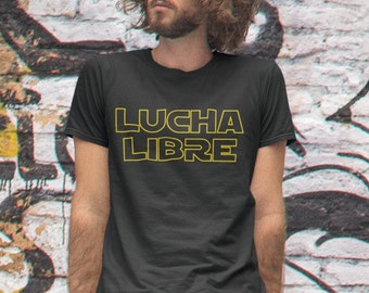May include: A black t-shirt with the words "LUCHA LIBRE" in yellow outlined text.