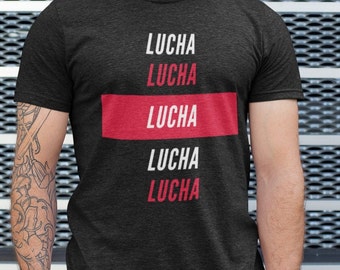 May include: A black t-shirt with the word "LUCHA" repeated five times in white and red lettering. The word "LUCHA" is repeated twice in white, then once in red, and then twice more in white.