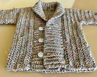 Crocheted baby cardigan in gender neutral colors