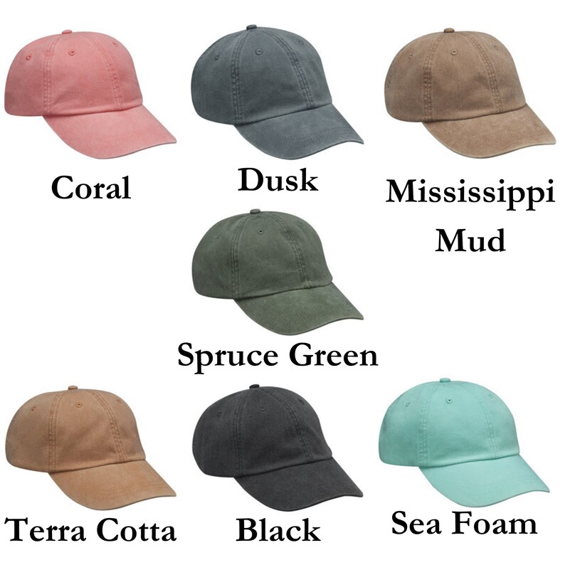 May include: Seven baseball caps in different colours. The colours are coral, dusk, Mississippi mud, spruce green, terracotta, black, and sea foam.