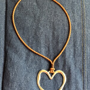Bohemian Styled Necklace made with Leather Rope as the chain and accented with an Antique Silver Heart Pendant.