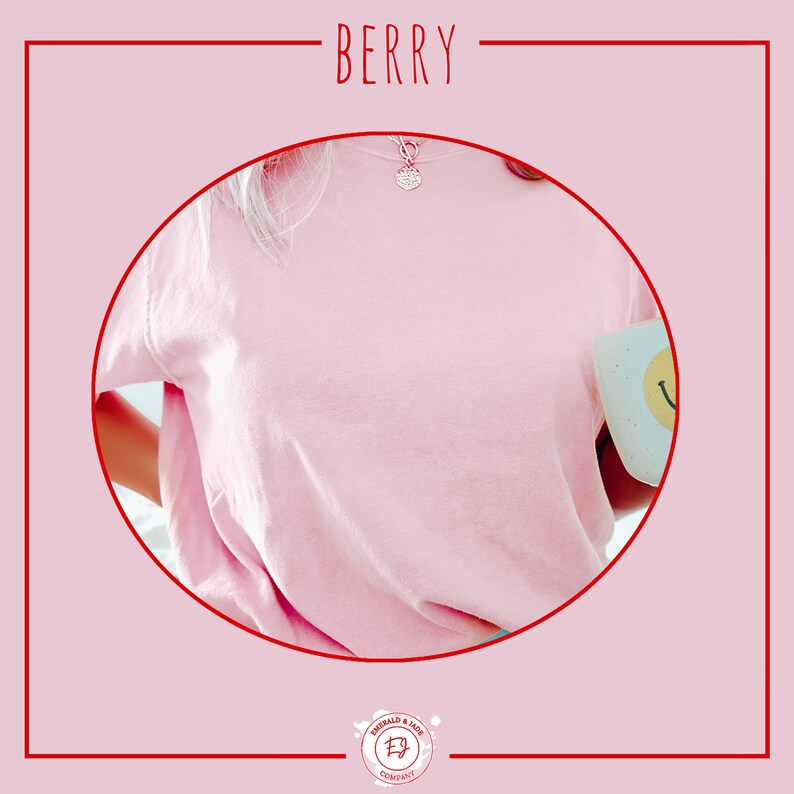 May include: A pink t-shirt with a silver necklace and a white mug with a smiley face design. The t-shirt is made of a soft, comfortable fabric.