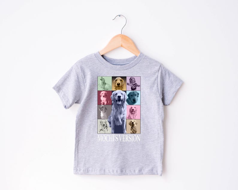 K&ouml;nnte beinhalten: Hellgraues Kinder-T-Shirt mit einer farbenfrohen Grafik eines Golden Retrievers. Die Grafik ist ein Raster aus neun Quadraten, jedes mit einem unterschiedlich farbigen Hintergrund und einem Portr&auml;t eines Golden Retrievers. Der Text "Mochi's Version" steht darunter.