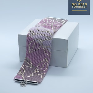 May include: A pink and gold beaded bracelet with a leaf pattern. The bracelet is on a white box with the text "GO BEAD YOURSELF" on a dark blue background.