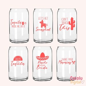 May include: Six clear glass can-shaped cups with pink text and graphics. The cups feature phrases like "Tequila Made Me Do It", "Let's Get Smashed", "Can't Touch This", "Tacos and Tequila", "Nacho Average Bride", and "Shake Your Maracas".