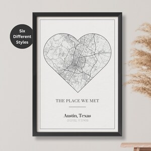 May include: A black and white map of Austin, Texas, in the shape of a heart. The text "The Place We Met" is below the map, followed by "Austin, Texas" and the coordinates "30.2672, 97.7431".