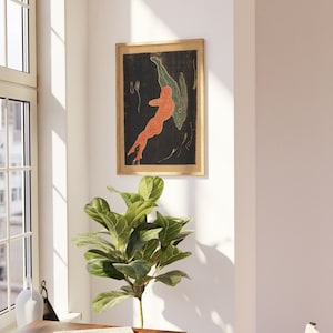 May include: A framed print of an abstract art piece featuring two figures in shades of orange and green against a black background.