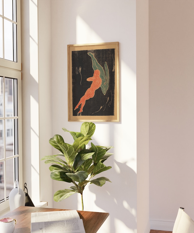 May include: A framed print of an abstract art piece featuring two figures in shades of orange and green against a black background.